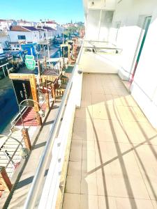 a balcony with tables and chairs on a boat at Flat Luxuoso Praia da Oura in Albufeira