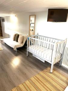 a living room with a crib and a couch at Vasiliki Guest House in Kalamata