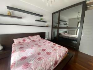 a bedroom with a pink bed and a mirror at Red House in Monfalcone