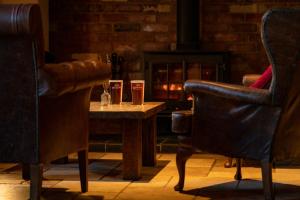 a table with two chairs and two glasses on it at Crab & Boar in Newbury