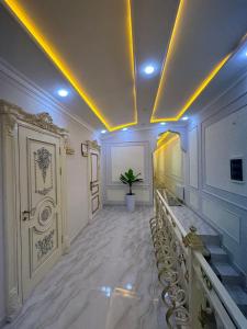 a large hallway with white marble floors and a staircase at Hotel Sherdor in Samarkand
