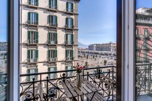 a balcony with a bench in front of a building at ATAROOMS Suites Napoli in Naples