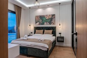 a bedroom with a large bed with towels on it at Villa 4A Visoko in Visoko +64 photos