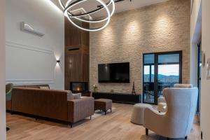 a living room with a couch and chairs and a tv at Villa 4A Visoko in Visoko
