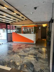 a lobby with an orange and white counter in a building at Luna Lara Hotel in Antalya