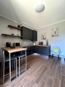 a kitchen with a table and chairs in a room at Sém chì, relaxing cottage in the mountains in Gromo