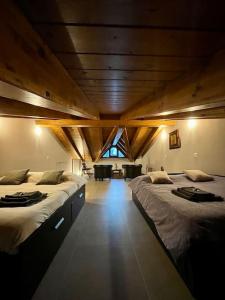 a large room with two beds in a room at Sém chì, relaxing cottage in the mountains in Gromo