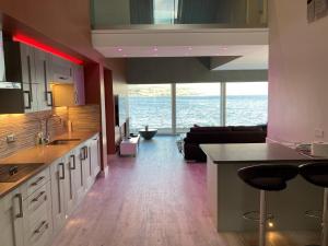 a large kitchen with a view of the ocean at Ferrypoint House in Rhu