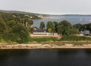 an aerial view of a house on an island in the water at Ferrypoint House in Rhu