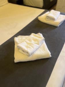 two white towels sitting on top of a counter at Luna Lara Hotel in Antalya