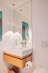 a bathroom with a sink and a mirror at Luxus-Apartements direkt am Attersee in Seewalchen