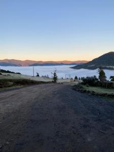 an empty road with a view of a body of water at Cabana Efatah - Pousada Colina dos Ventos in Urubici