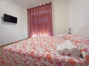 a bedroom with a bed with towels on it at Milly Rooms in Celle Ligure