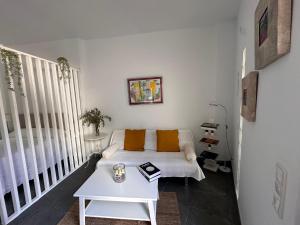 a living room with a couch and a table at Casa Gloria in Málaga