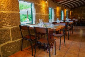 a row of tables and chairs in a restaurant at Casa Videira - Hotel rural cerca del mar in Bueu