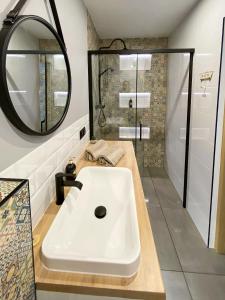 a bathroom with a white sink and a mirror at 34_Boho - DeerRest Apart in Jelenia Góra
