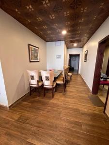 a dining room with a table and chairs at Blue sky Apartment in Nathia Gali