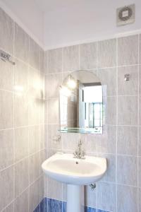 a bathroom with a sink and a mirror at Dagris Villa Studios in Kamari