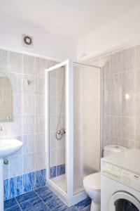 a bathroom with a shower and a toilet and a sink at Dagris Villa Studios in Kamari