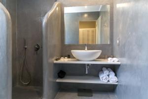 a bathroom with a sink and a mirror at Acroterra Rosa Luxury Suites & Spa in Akrotiri