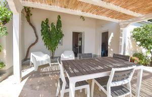 a wooden table and chairs on a patio at Casa DaviRì in Modica