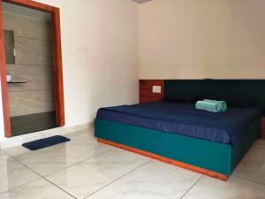 a bedroom with a blue bed in a room at Unique Couple Friendly Stay in Morbi