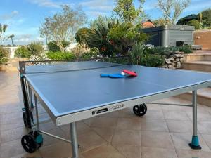 a ping pong table with a ping pong ball on it at Villa GALVANA in Guia