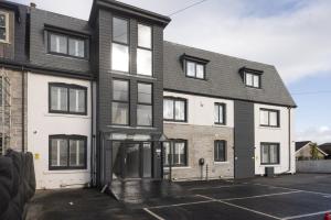 an empty parking lot in front of a building at Beachview Apartment 5, Crantock, Newquay in Crantock