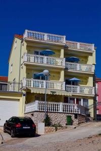 a car parked in front of a building with balconies at Apartment Crikvenica, Vinodol 2 in Crikvenica