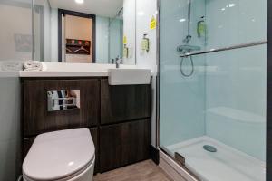 a bathroom with a toilet and a sink and a shower at easyHotel Milton Keynes in Milton Keynes
