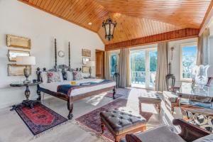 a bedroom with a bed in a room with a wooden ceiling at SaffronStays Naiintara in Nainital