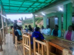 a group of people sitting at a table at African Tent Resort in Kabale