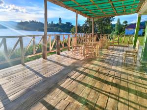 a deck with chairs and a view of the water at African Tent Resort in Kabale