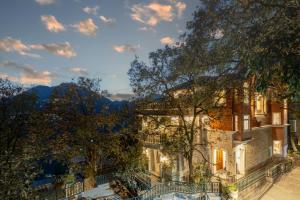 a house with a view of the mountains at SaffronStays Naiintara in Nainital