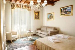 a living room with a bed and a couch at Agriturismo Podere Bucine Basso in Lari +69 photos