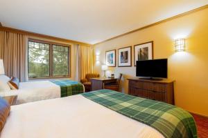 a hotel room with two beds and a flat screen tv at 4006 Suncadia Lodge Pool and Hot-Tub Access with Hotel Amenities in Cle Elum +19 photos