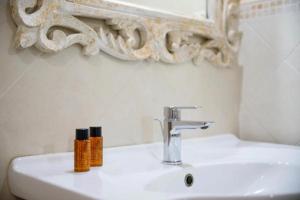 a bathroom sink with two bottles on top of it at Agriturismo Podere Bucine Basso in Lari