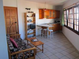 a kitchen with a couch and a table in a room at Apartamentos Montecristo in Santa Cruz de la Palma