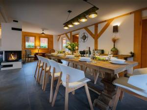 a large dining room with a long table and chairs at Chalet Evonyx - OVO Network in Samoëns