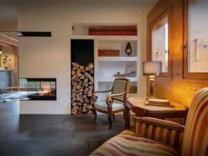 a living room with a table and a fireplace at Chalet Evonyx - OVO Network in Samoëns