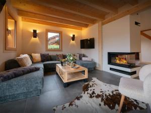 a living room with a couch and a fireplace at Chalet Evonyx - OVO Network in Samoëns