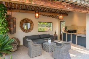 a patio with a couch and a table and chairs at high standard provencal bastide with heated pool in lourmarin in the luberon, vaucluse. 10 people in Lourmarin