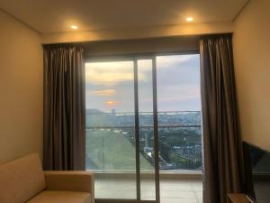 a room with a large window with a view at The Song Apartment Vung Tau Sea view in Vung Tau
