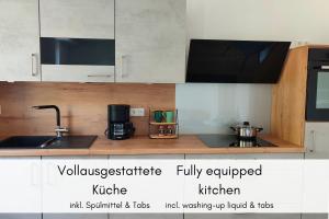 a kitchen with white cabinets and a sink at Moselidyll im Alten Winzerhaus am Calmont in Bremm