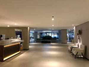 a lobby of a building with chairs and a counter at The Song Apartment Vung Tau Sea view in Vung Tau