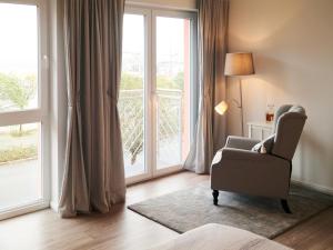 a living room with a chair and a large window at Ferienwohnung Nordlicht in Barth