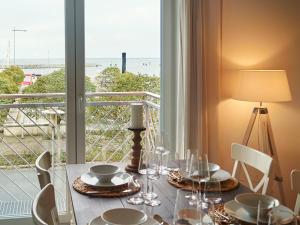 a dining room table with a view of the ocean at Ferienwohnung Nordlicht in Barth
