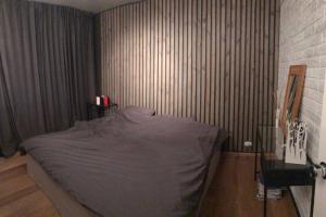 a bedroom with a bed with a gray blanket at COZY APPARTMENT Free parking in Reykjavík