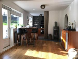 a kitchen with a table and stools in a room at COZY APPARTMENT Free parking in Reykjavík