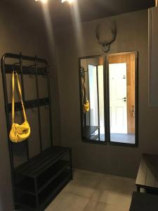 a bathroom with a mirror and a yellow purse at COZY APPARTMENT Free parking in Reykjavík
